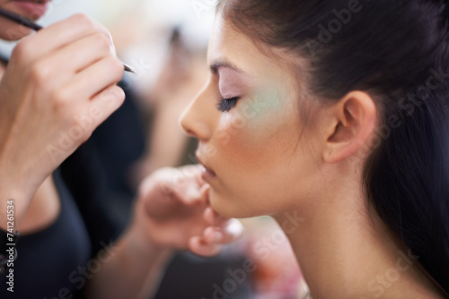 Woman, profile and makeup artist with hands for beauty, beautician and brush for color powder and glamour. Eyeshadow, cosmetology and face cosmetic care with people backstage for styling and makeover photo