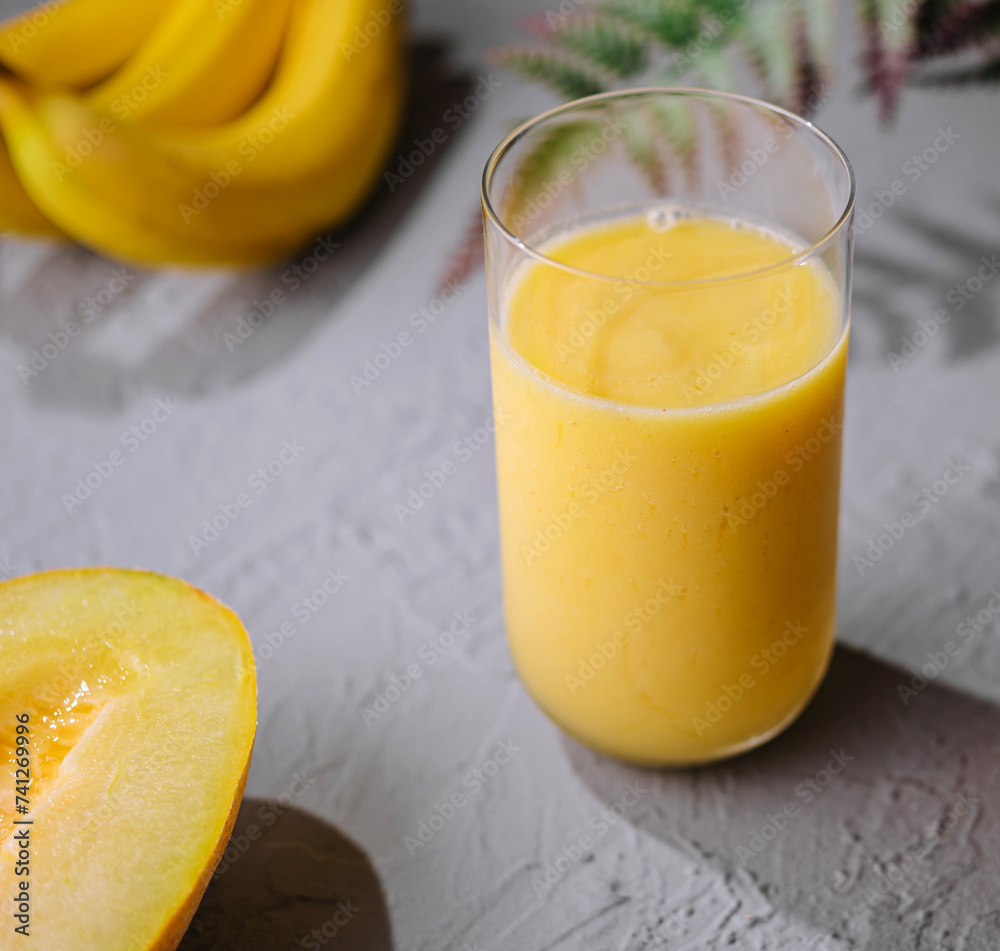 Yellow smoothie of mango, banana and orange Yellow smoothie of mango, banana and orange