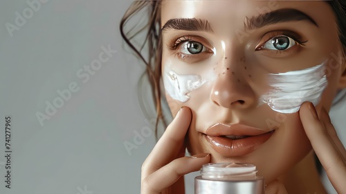 Girl applying face cream on skin, skin products, beauty products.
