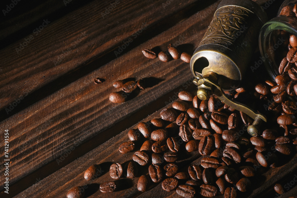 Coffee beans and coffee grinder on the kitchen table close up background. Front view. Coffee beans and coffee grinder on the kitchen table close up background. Front view.