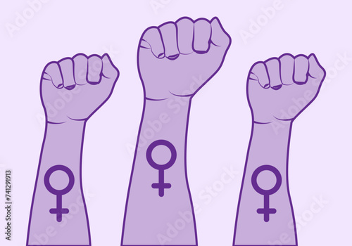 Puños morados levantados por el feminismo.