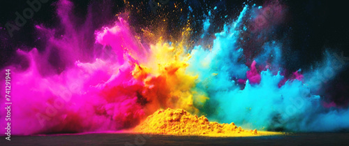 Colored splash explosion of multi-colored powder on a dark background.