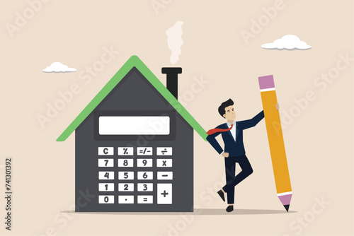 House mortgage calculation, real estate investment or home decoration money concept, residential budget, businessman agent or broker holding pencil with house calculator.