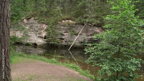 The Ahja River panorama in summer. Sandstone outcrop and virgin cave. photo