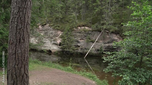 The Ahja River panorama.. Sandstone outcrop and virgin cave. photo