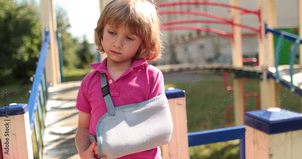 A handsome boy with a broken arm in a bandage. Children's injuries, broken arm, arm in a bandage. A handsome boy with a broken arm in a bandage. Children's injuries, broken arm, arm in a bandage.