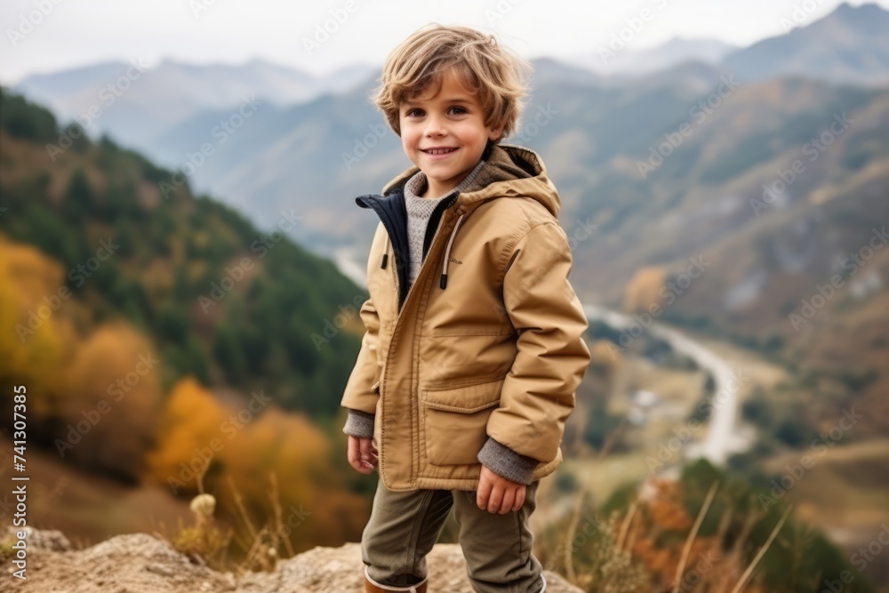Portrait of a little boy on the background of the autumn mountains