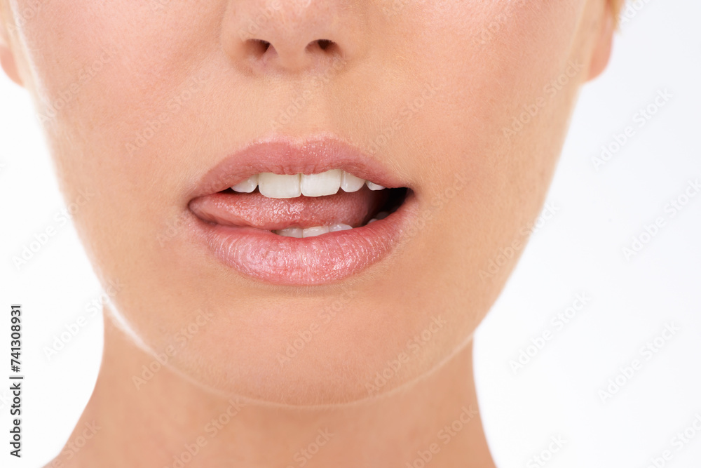 Obraz premium Closeup, mouth and woman with skincare, wellness and person isolated on a white studio background. Lips, gloss and model with dental and makeup with shine and glowing with smooth, clear and soft skin