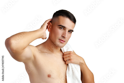 Young smiling man with towel on shoulders posing at camera on white background
