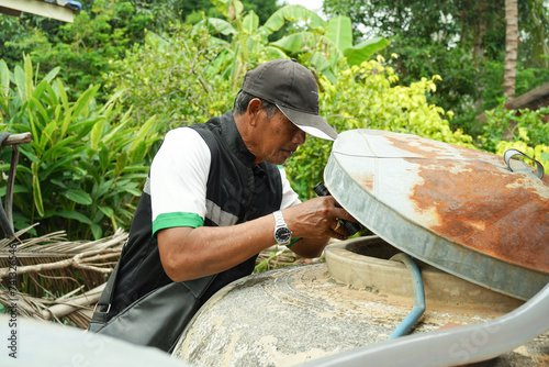 Thai man The survey of Aedes Aegypti larvae mosquitoes, Dengue fever prevention. photo