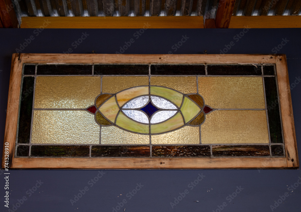 Stained glass window with wooden trim