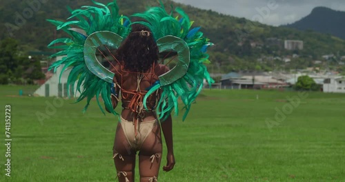 Dressed in her vibrant carnival attire, a young girl adds to the colorful spectacle of Trinidad's tropical Carnival festivities. photo