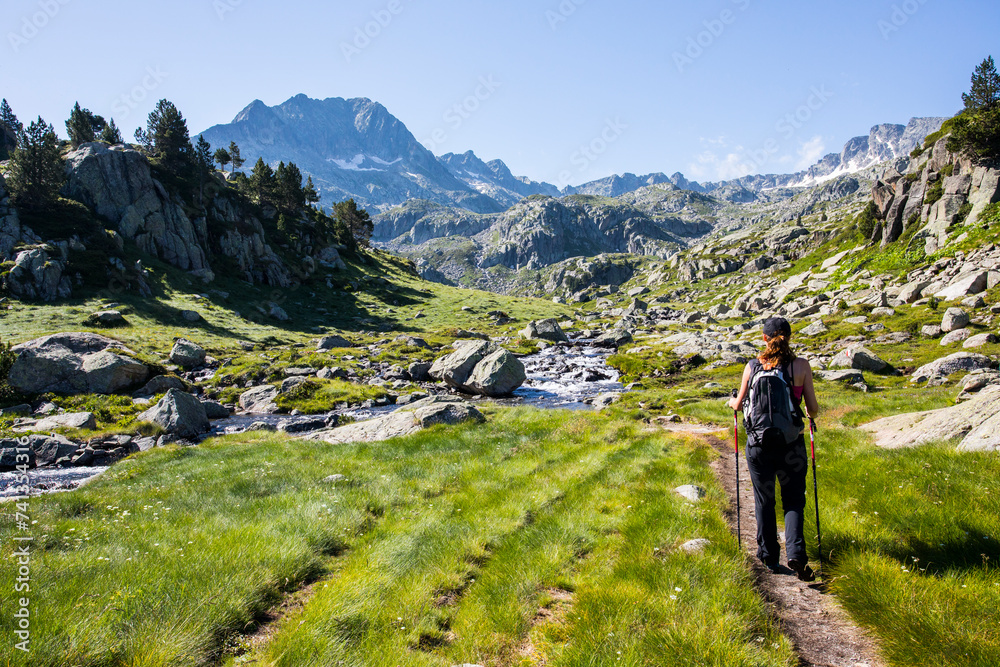 Young hiker girl summit to Ratera Peak in Aiguestortes and Sant Maurici National Park, Spain