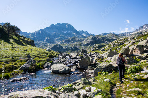 Young hiker girl summit to Ratera Peak in Aiguestortes and Sant Maurici National Park, Spain photo