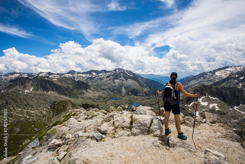 Young hiker girl summit to Montardo Peak in AIguestortes and Sant Maurici National Park, Spain