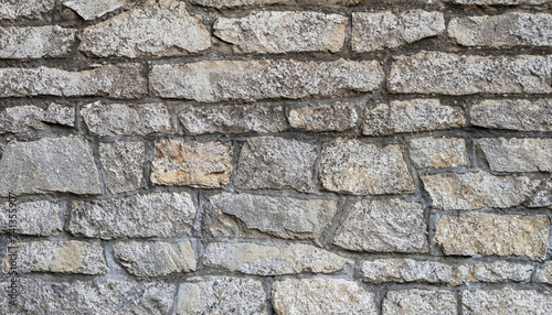 Masonry texture of natural gray stone  wall with a rough surface