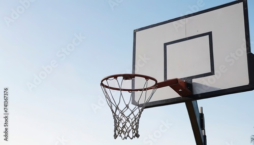 Close up basketball hoop on empty outdoor court © Emilian