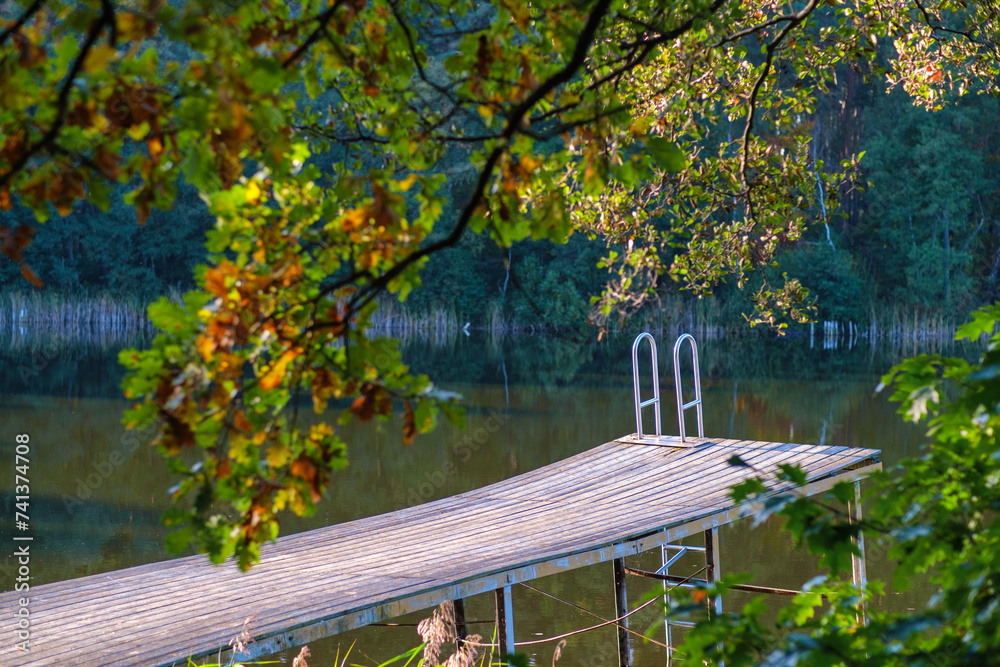 Naklejka premium Beautiful sunset over lake with wooden pier.