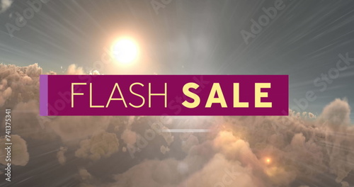 Digital image of flash sale text over purple banner against sun shining in the sky