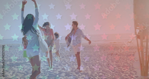 Multiple blinking stars against group of friends walking at the beach
