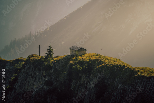 small cabin on a misty morning in the mountains