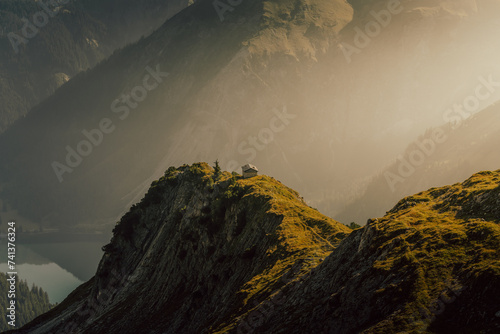 small cabin on a misty morning in the mountains