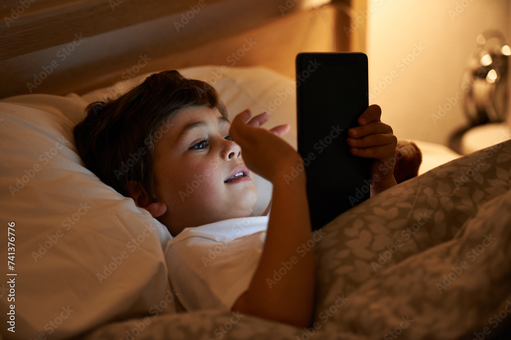 Boy, tablet and bed with night, digital and technology for social media or learning. Child, bedroom and connectivity for knowledge, youth and elearning or internet surfing at home with touchscreen Boy, tablet and bed with night, digital and technology for social media or learning. Child, bedroom and connectivity for knowledge, youth and elearning or internet surfing at home with touchscreen