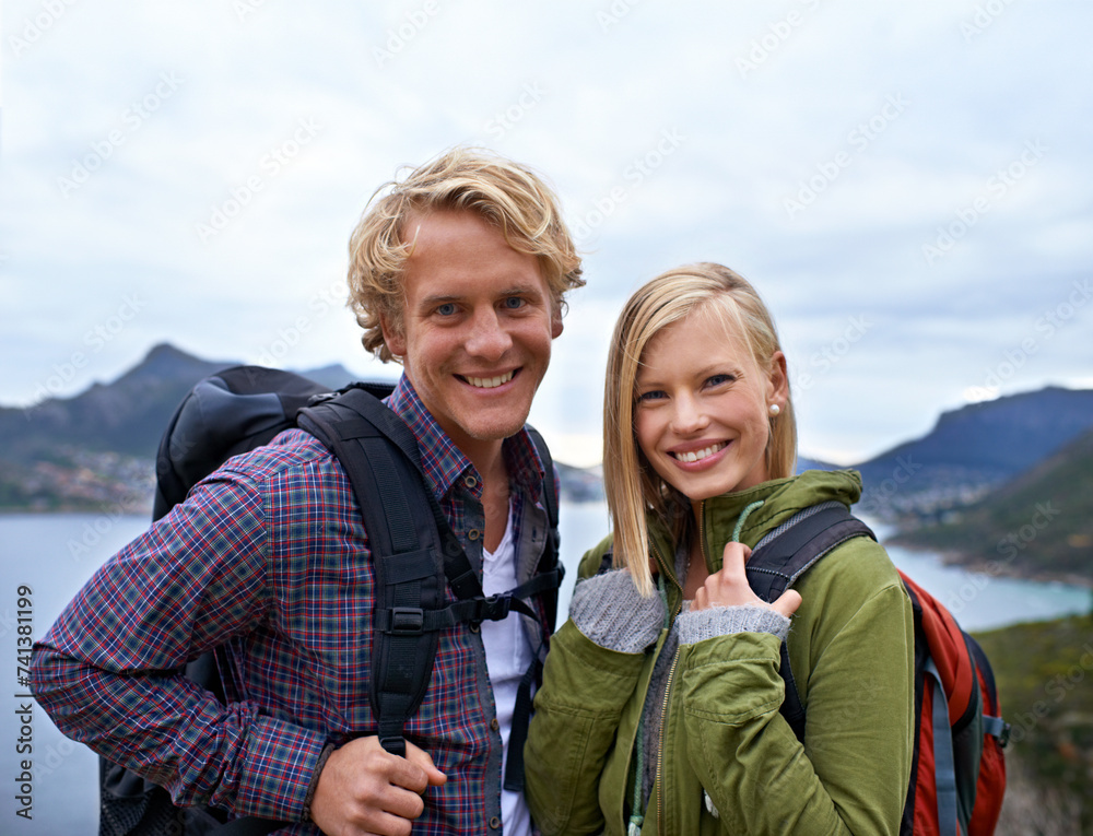 Happy couple, portrait and hiking with backpack on mountain for sightseeing, travel or outdoor journey in nature. Face of young man, woman or hikers carrying bag for trekking, fitness or adventure Happy couple, portrait and hiking with backpack on mountain for sightseeing, travel or outdoor journey in nature. Face of young man, woman or hikers carrying bag for trekking, fitness or adventure