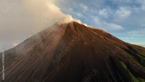 Aerial view of Karangetang Volcano with orange smoke and majestic summit, Siau, Indonesia. photo