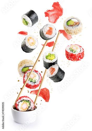 Flying pieces of sushi with chopsticks isolated on white background. Concept of flying sushi with ingredients. With clipping path.