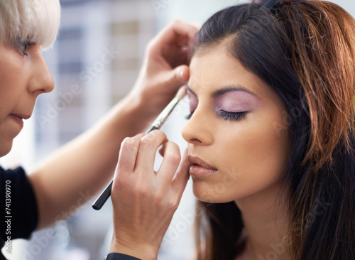 Women  beautician and face with makeup at salon for cosmetics  cosmetology and beauty with wellness. Model  people and eyeshadow application with skincare  powder glow and getting ready with relax