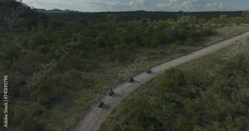 Aerial view of people riding with a quad motorbike in Balule Nature Reserve, Maruleng, Limpopo region, South Africa. photo