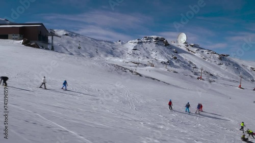 chairlifts in operation at a snowy ski resort