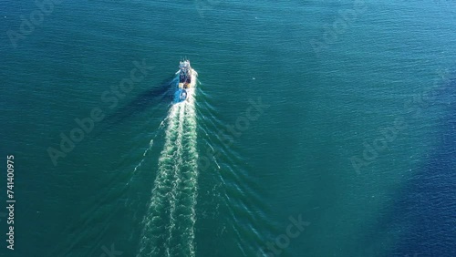 Aerial view of Fishing boat steaming off of Baranof Island, Tongass National Forest, Sitka, Alaska, United States. photo