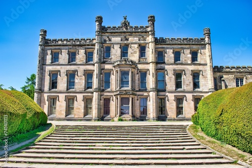 Elvaston, Derby, Derbyshire, England, UK. June 20, 2020 Front view of Elvaston Castle on a sunny day with surrounding green parkland and blue sky. This was during the Covid 19 Pandemic. photo