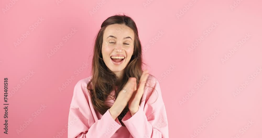 Young woman applauding after presentation in a conference isolated on pink background. Applauding girl is very glad and happy, she claps hands because of excellent news, support. Young woman applauding after presentation in a conference isolated on pink background. Applauding girl is very glad and happy, she claps hands because of excellent news, support.