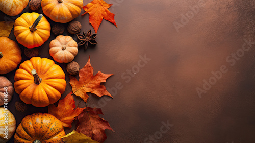 A group of pumpkins with dried autumn leaves and twig, on a plastic surface