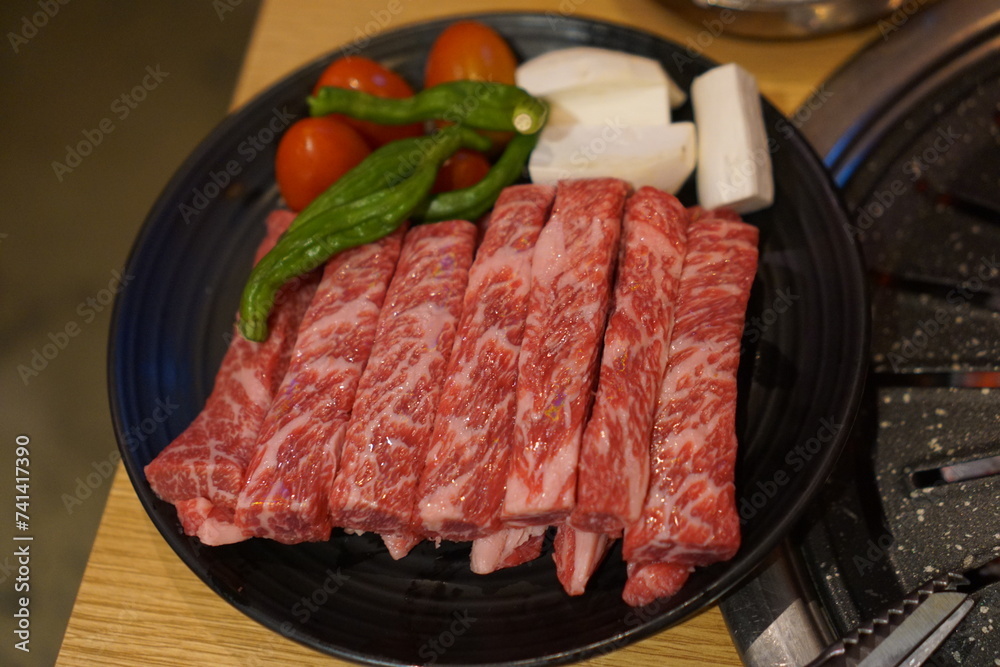 Beef plated with tomatoes, mushrooms and peppers