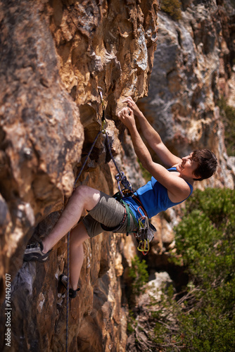 Rock climbing, woman and fitness with rope, travel and gear to explore in nature on a mountain. Cliff, hiking and sport with athlete and adventure for workout, exercise and climber training outdoor