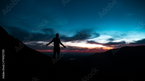 Spectacular sunset in the mountains with the silhouette of a man