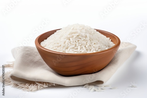 A bowl with uncooked white rice on a white background. Concept of food staple, raw grains, cooking ingredient, healthy food.