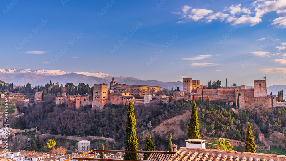 View of the Alhambra in Granada at sunset from the Mirador de San Nicolas, in Andalucia, Spain.
