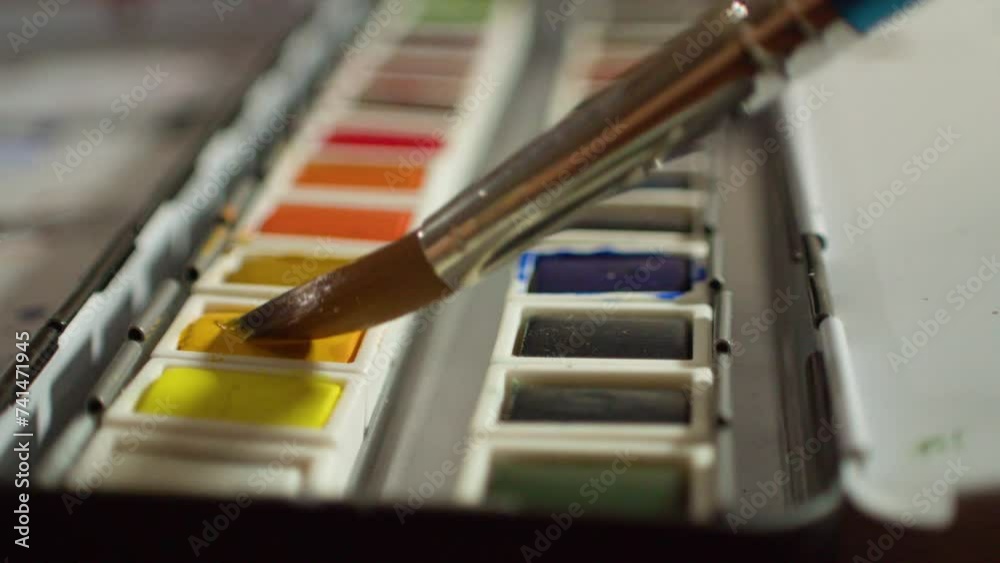 Selecting yellow color from watercolor palette