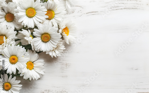 a bouquet of garden camomile flowers on a white wooden table.