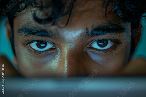 photo of Indian student's hand scrolling through digital study materials on a tablet device, with a look of determination in their eyes, shot from hiding camera, minimalistic style photo