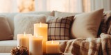 A simple and inviting coffee table setup with candles and a blanket, perfect for creating a warm and cozy atmosphere