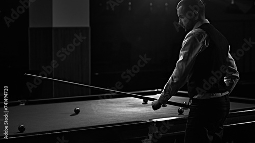 Canvas Print Man in waistcoat playing snooker game, billiards, monochrome image capturing intense focus