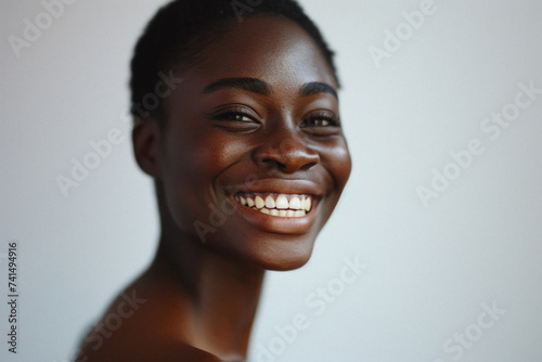 Happy attractive African American woman of middle age posing for beauty portrait. Pretty Black ethnic lady smiling on background, attractive female model advertising skin care treatment. Close up face