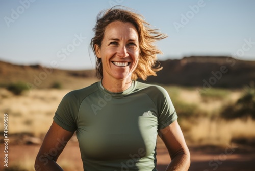 Portrait of a smiling middle-aged woman standing in the desert