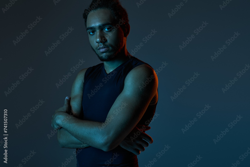 handsome athletic african american man in sportwear posing with arms crossed and looking at camera handsome athletic african american man in sportwear posing with arms crossed and looking at camera